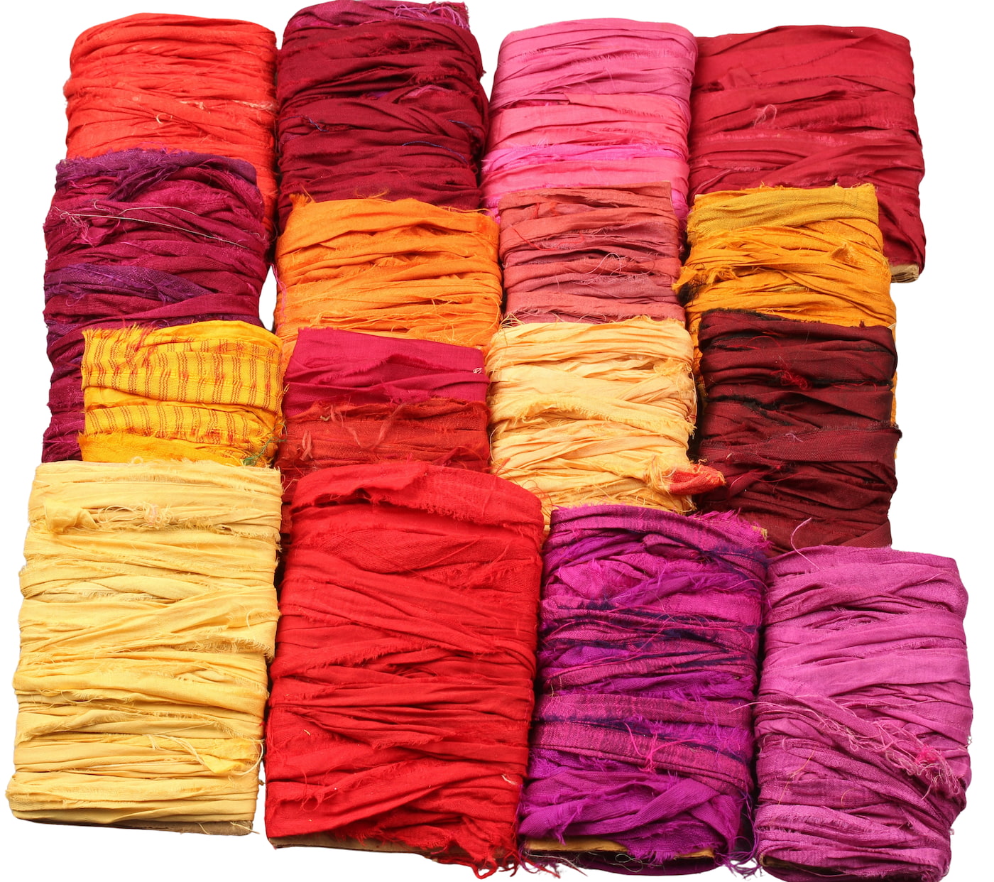 Assorted red and yellow sari silk ribbons in 16 shades wrapped on cardboard