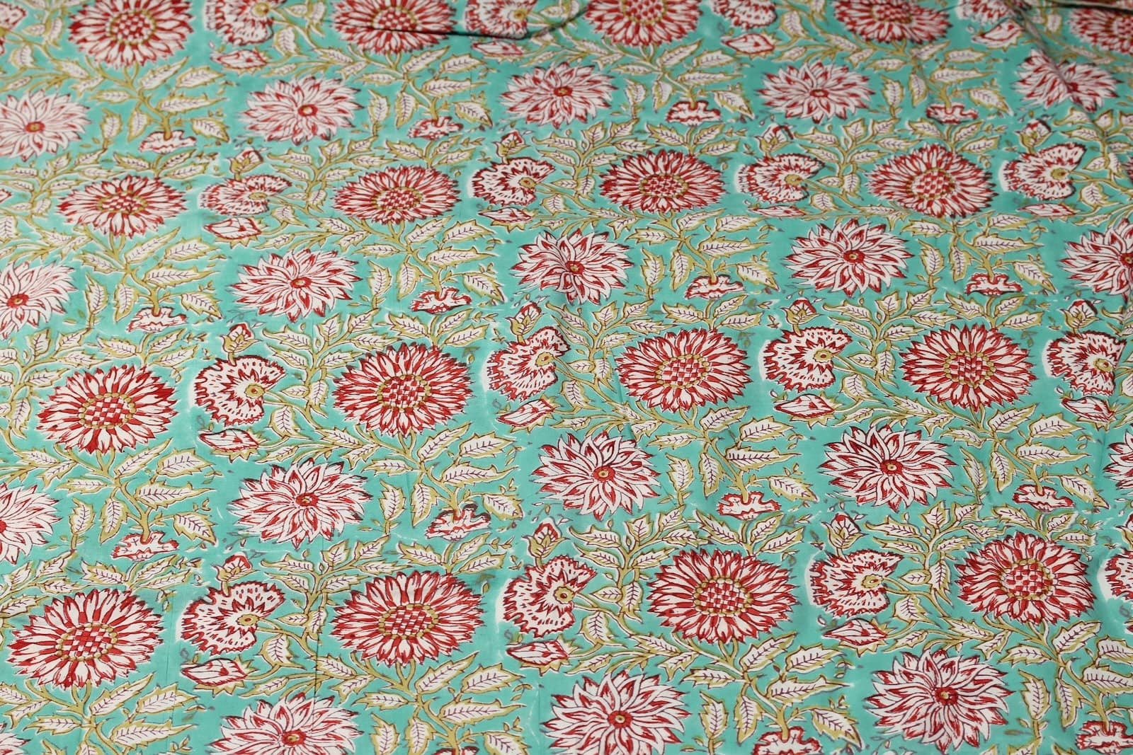 Aqua Chrysanthemum Garden hand block printed cotton fabric featuring red and ivory chrysanthemum flowers on an aqua background