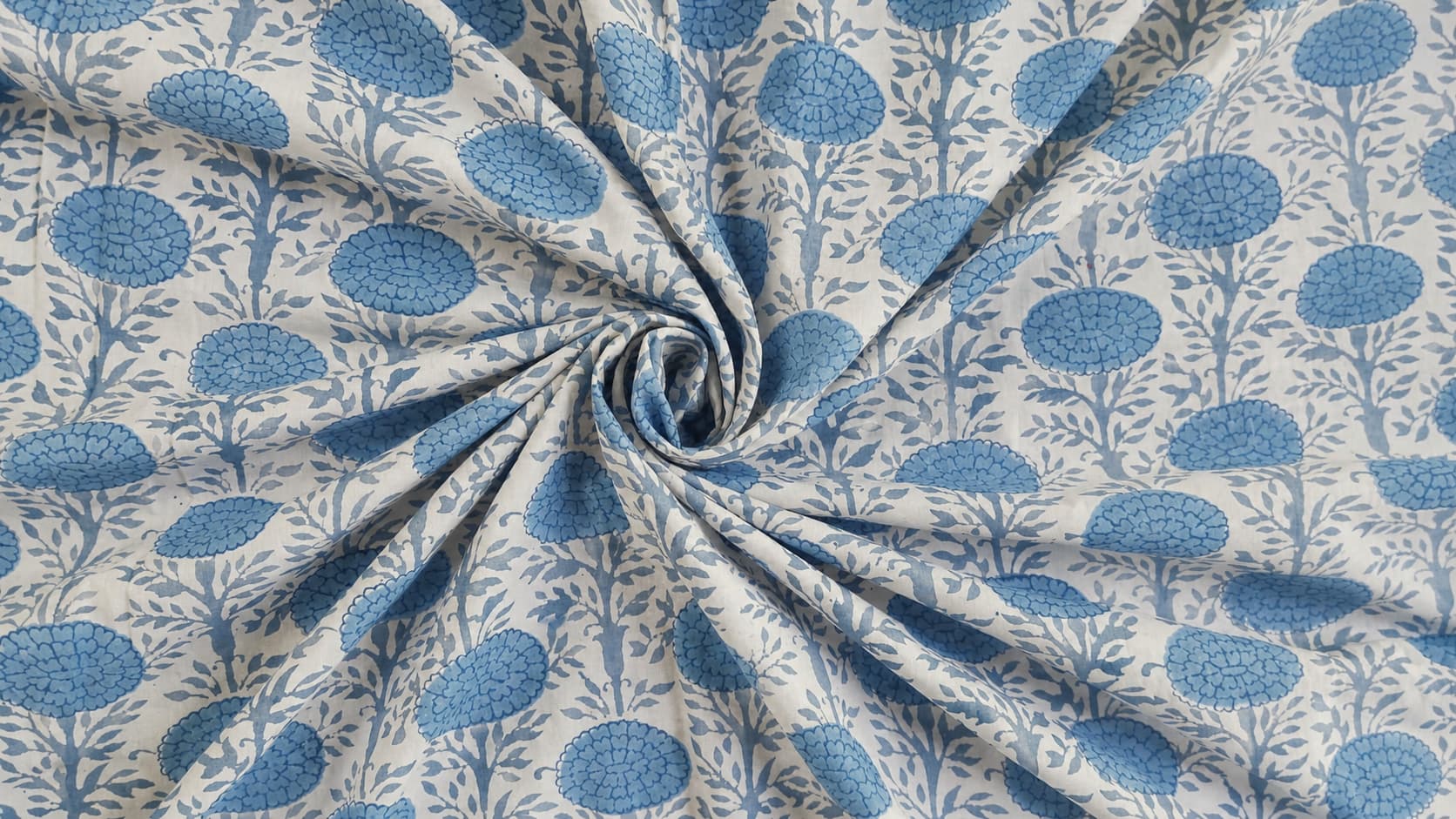 Powder blue block printed cotton fabric showing drape and texture
