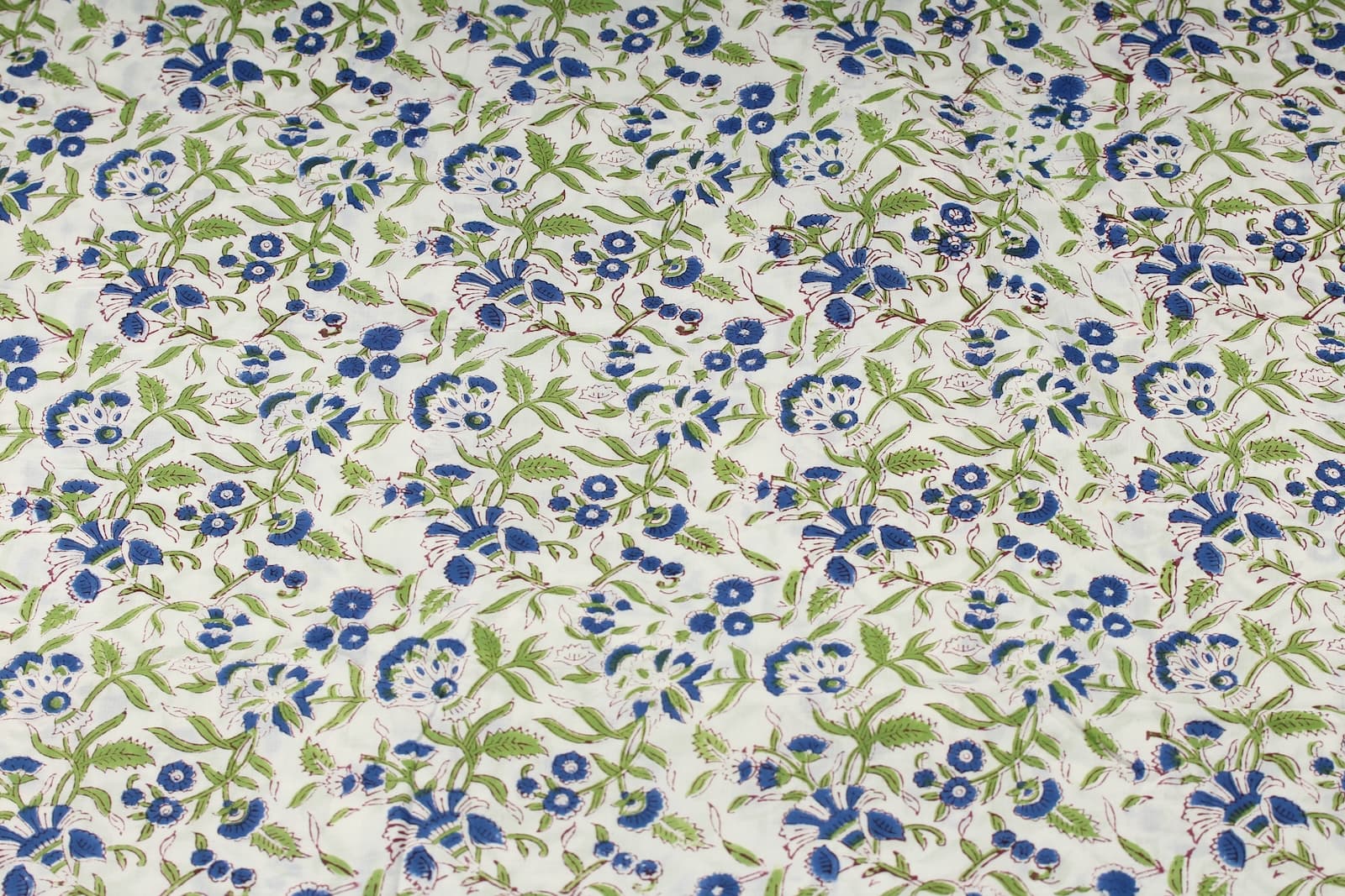 Bluebell Grove block printed cotton fabric showing repeating blue and green botanical pattern