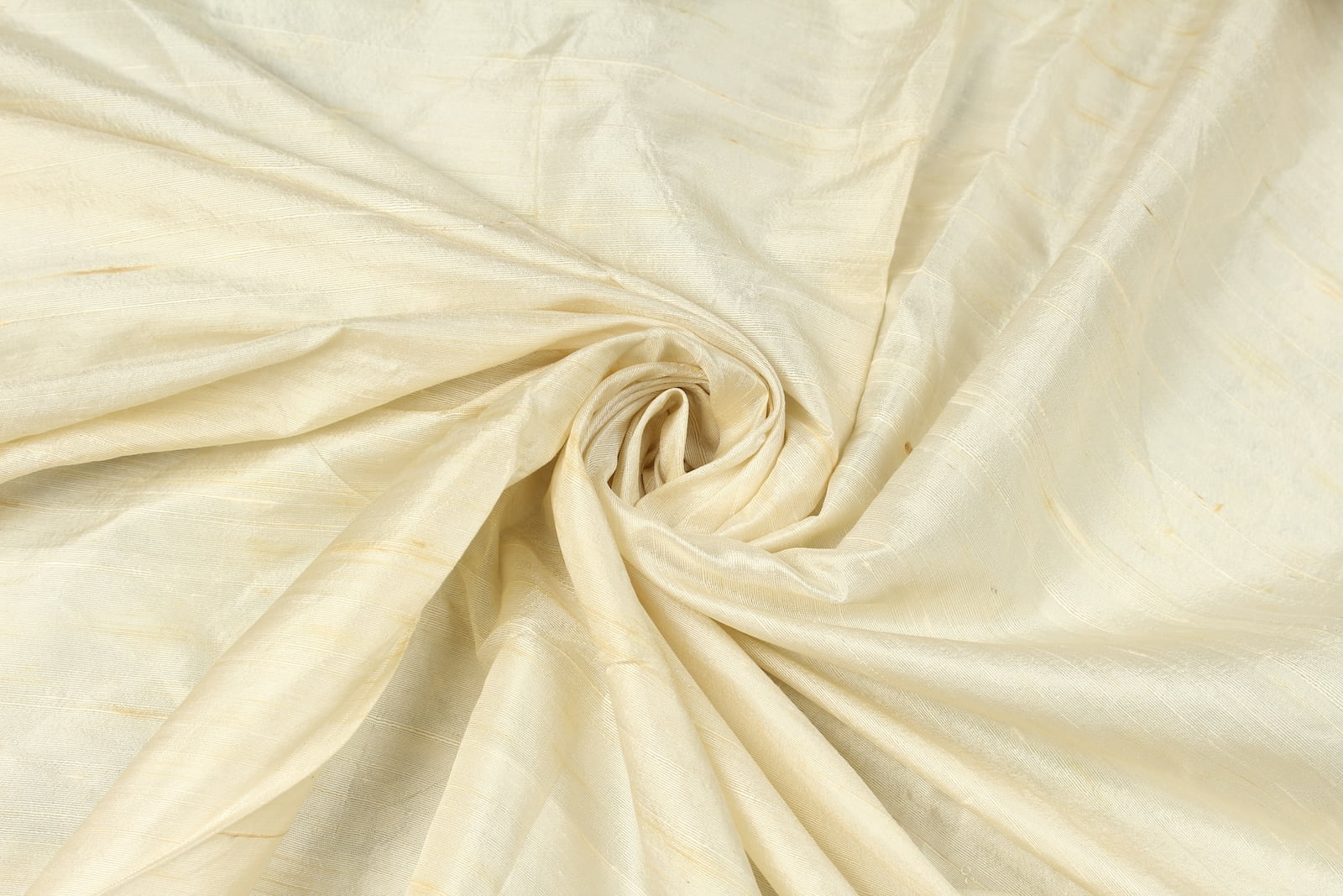 Ivory Dupion Silk Fabric arranged in elegant swirling folds highlighting its luminous sheen, crisp texture, and refined ivory colouring