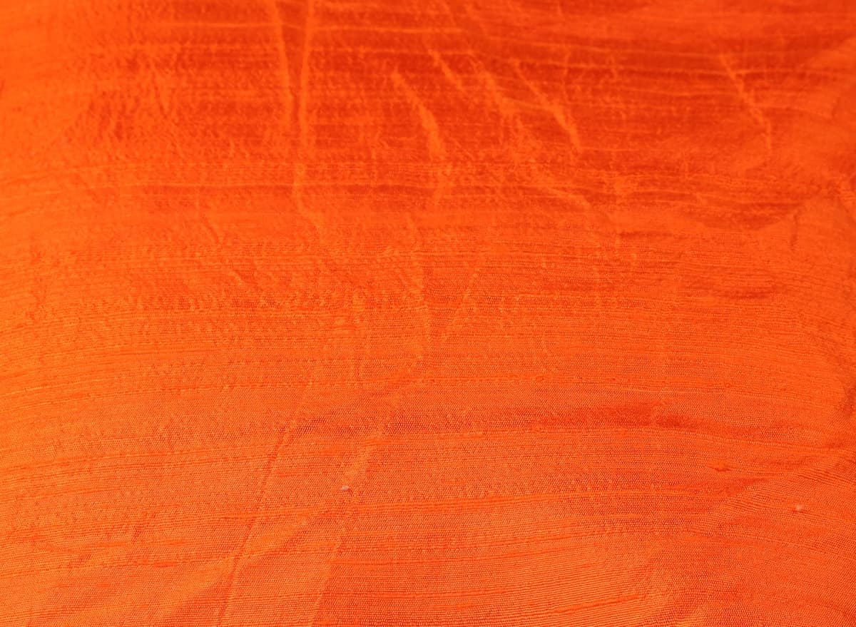 Close-up detail of Orange Dupion Silk Fabric surface texture