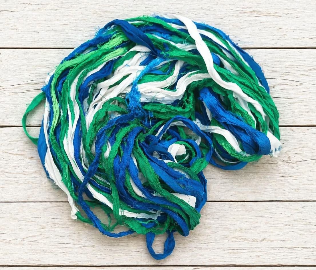 Coiled Ocean Breeze sari silk ribbon yarn showing vibrant ocean-inspired colors