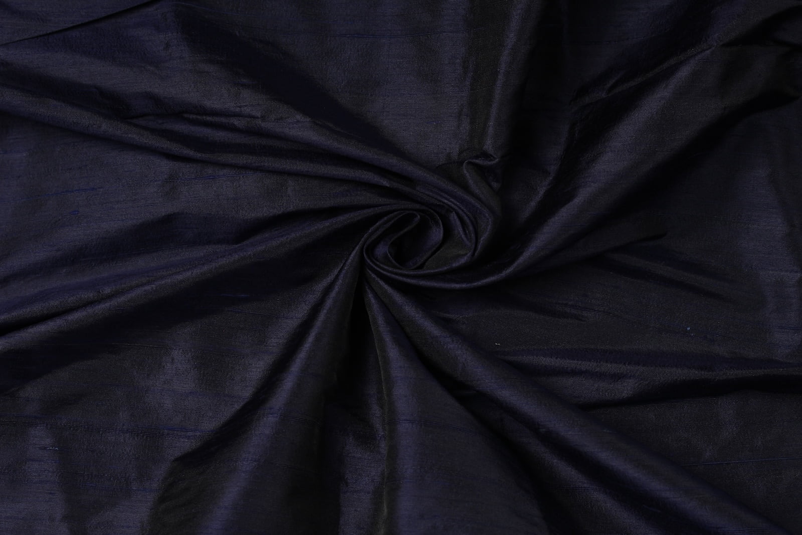 Deep Navy Dupion Silk Fabric arranged in elegant swirling folds highlighting its luxurious sheen and natural dupion silk texture
