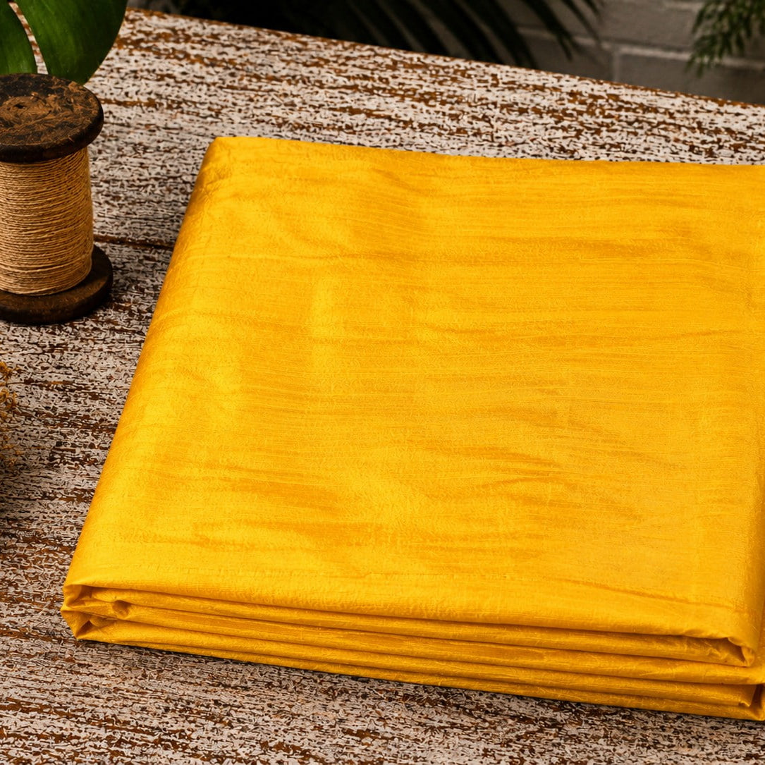 Golden Yellow Dupion Silk Fabric folded to showcase its radiant golden-yellow colour, natural silk texture, and lustrous sheen