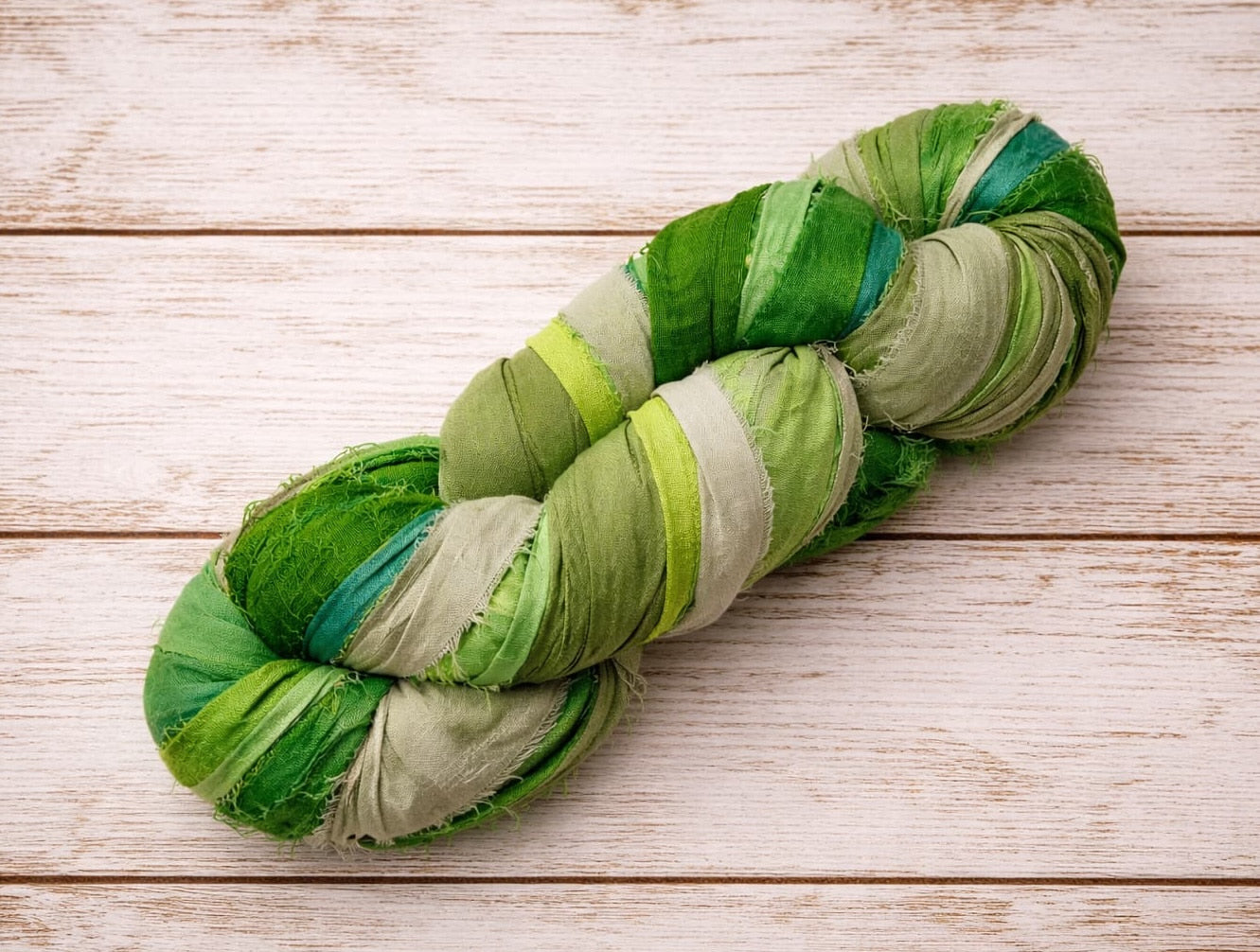 Emerald Meadow recycled sari silk ribbon yarn in shades of emerald green, sage, lime and teal
