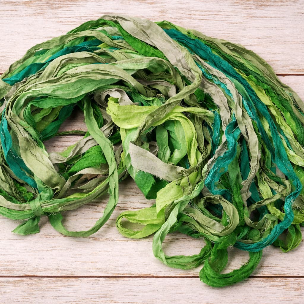 Single skein of Emerald Meadow recycled silk ribbon yarn for weaving and crochet