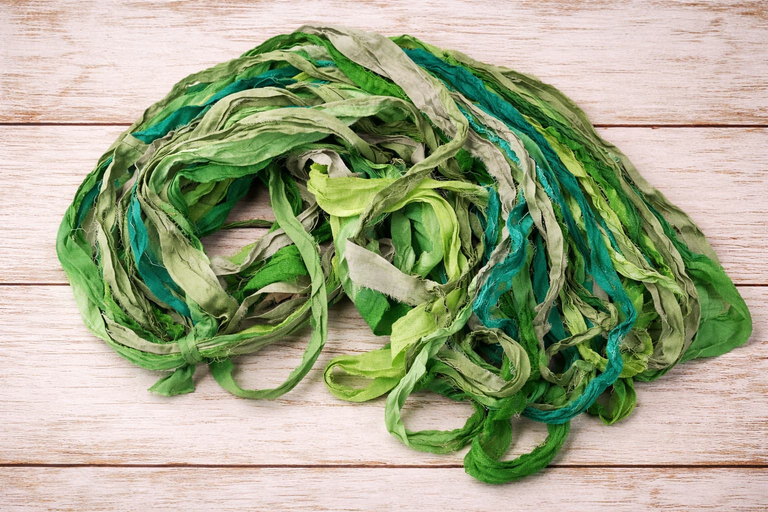 Single skein of Emerald Meadow recycled silk ribbon yarn for weaving and crochet