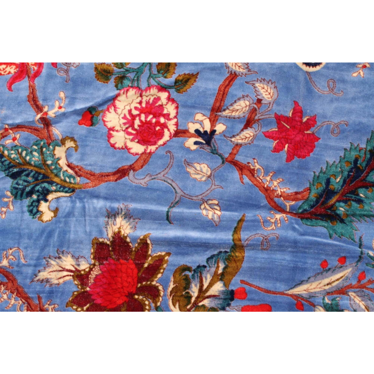 Close-up of red floral print on light blue hand-printed cotton velvet fabric