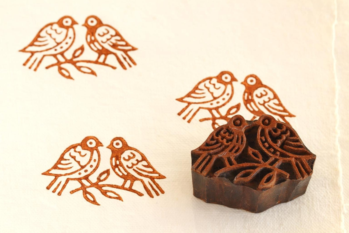 Hand carved wooden love birds printing block with brown stamped pattern on fabric