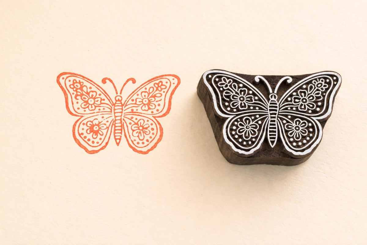 Butterfly wooden block printing stamp used on fabric showing detailed textile print hand carved stamp