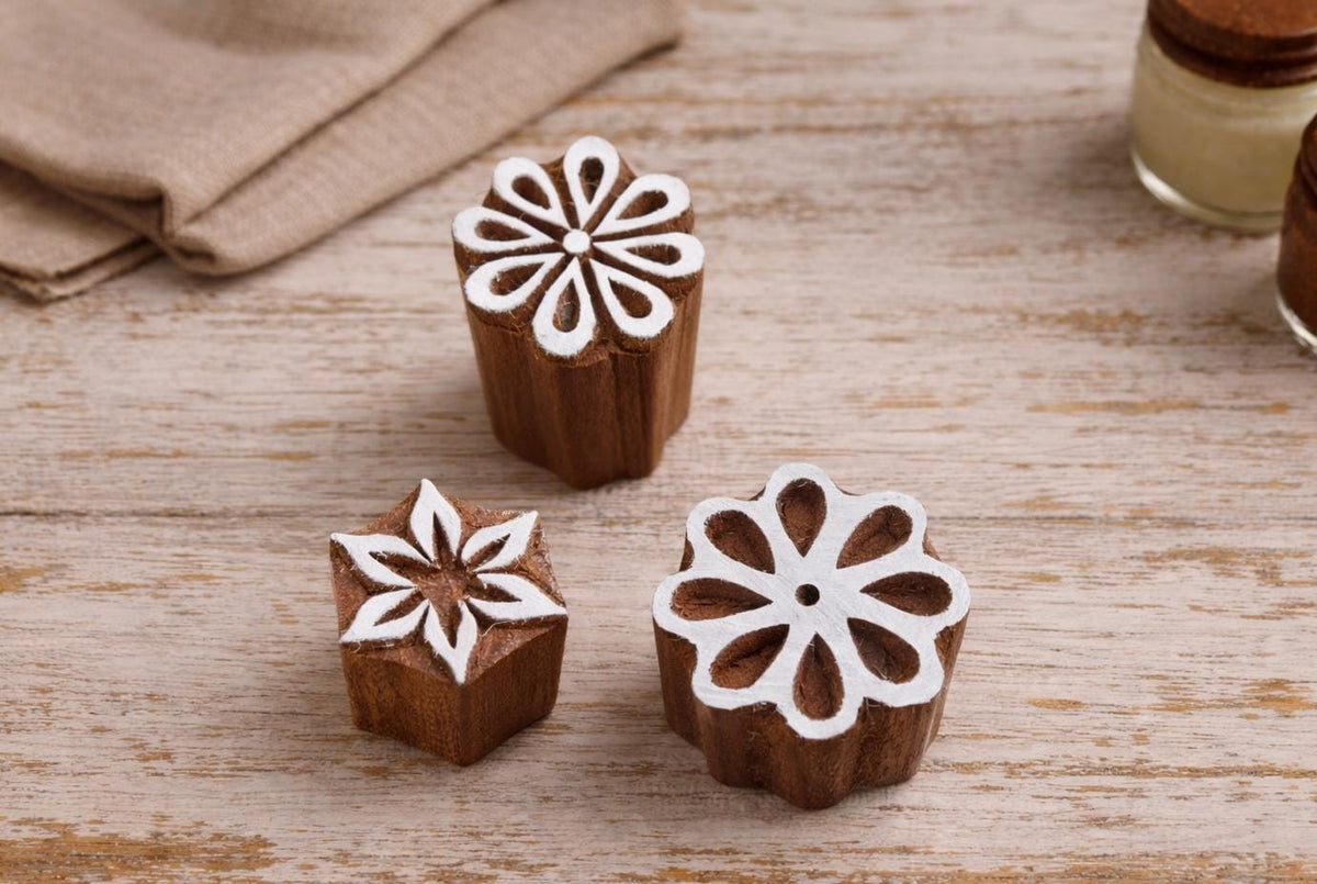 Set of three hand carved wooden flower stamps with star, round, and loop petal designs