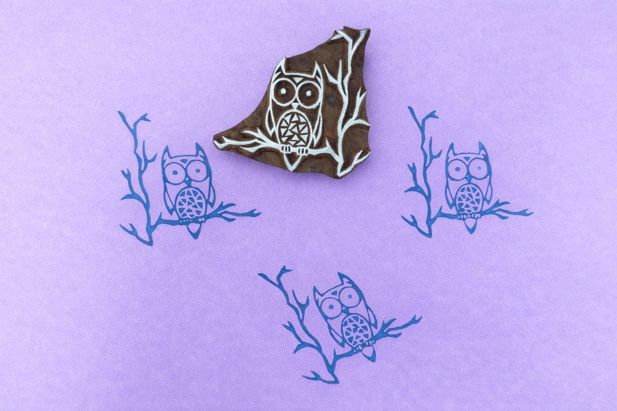 Hand carved owl wood block stamp printing a repeating owl pattern on paper or fabric