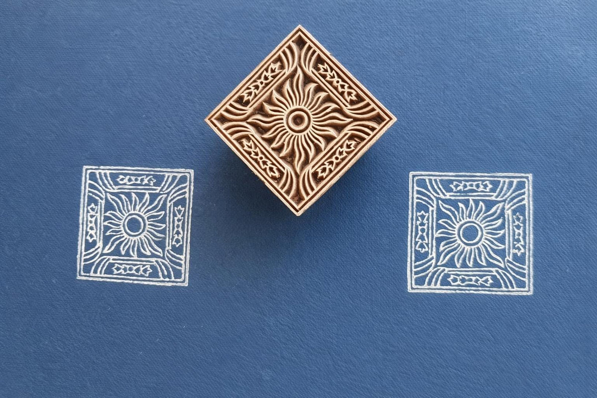 Hand carved wooden square stamp printing sun motif with decorative border