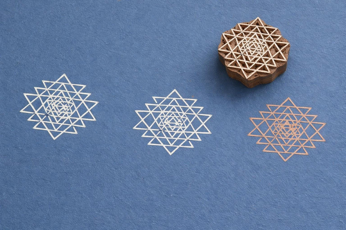 Hand carved wooden stamp printing sacred geometry star triangle pattern