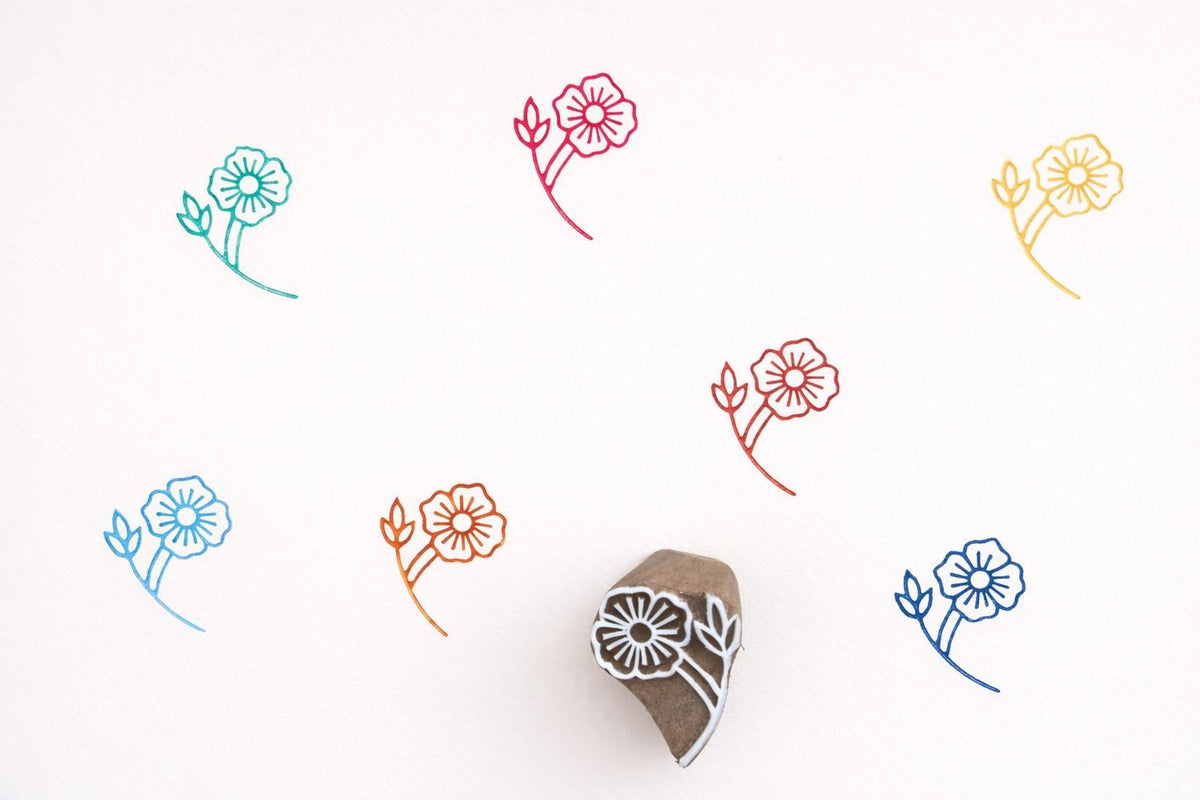 Hand carved wooden stamp printing detailed layered petal flower pattern