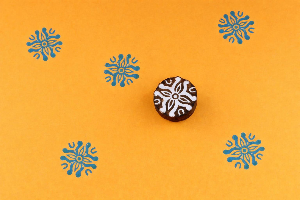 Hand carved wooden printing stamp with sunburst floral medallion design for fabric printing, textile patterns, and clay pottery