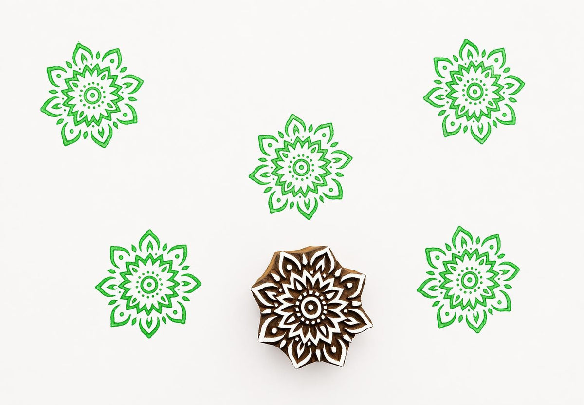 Hand carved wooden printing block with an ornamental radial pattern inspired by henna style symmetry for textile and surface design.