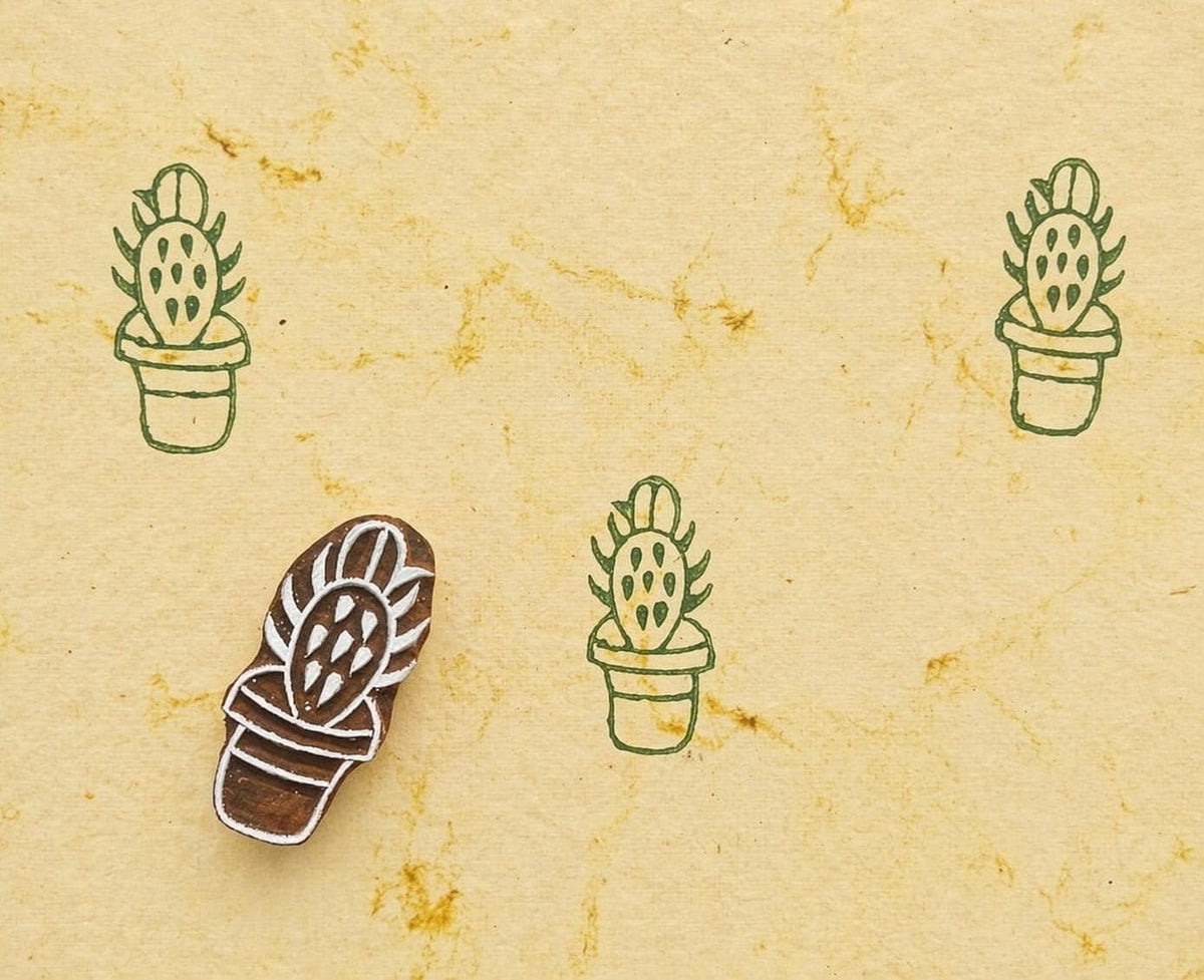 Prickly pear cactus stamp making green repeating pattern on handmade paper