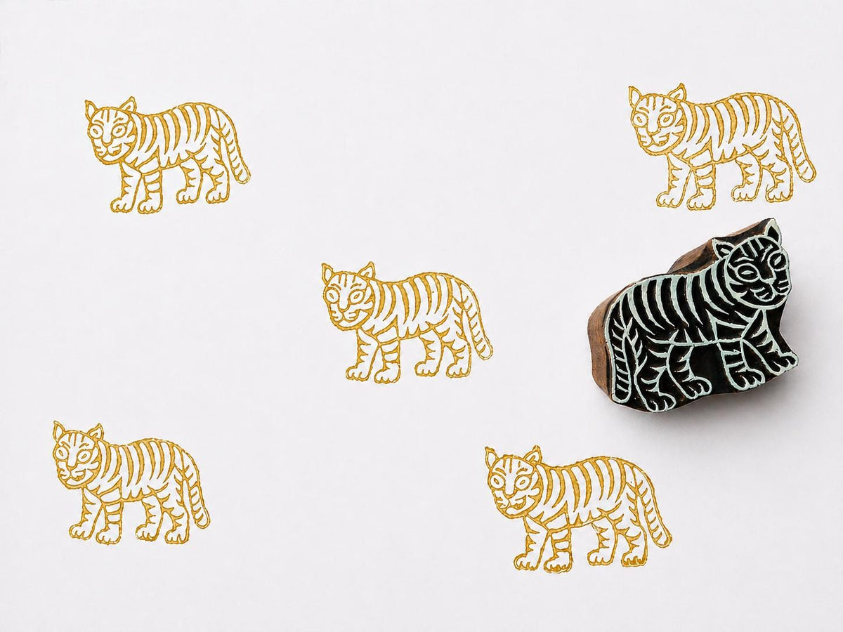 Hand carved wooden tiger block stamp printing striped tiger pattern on white background