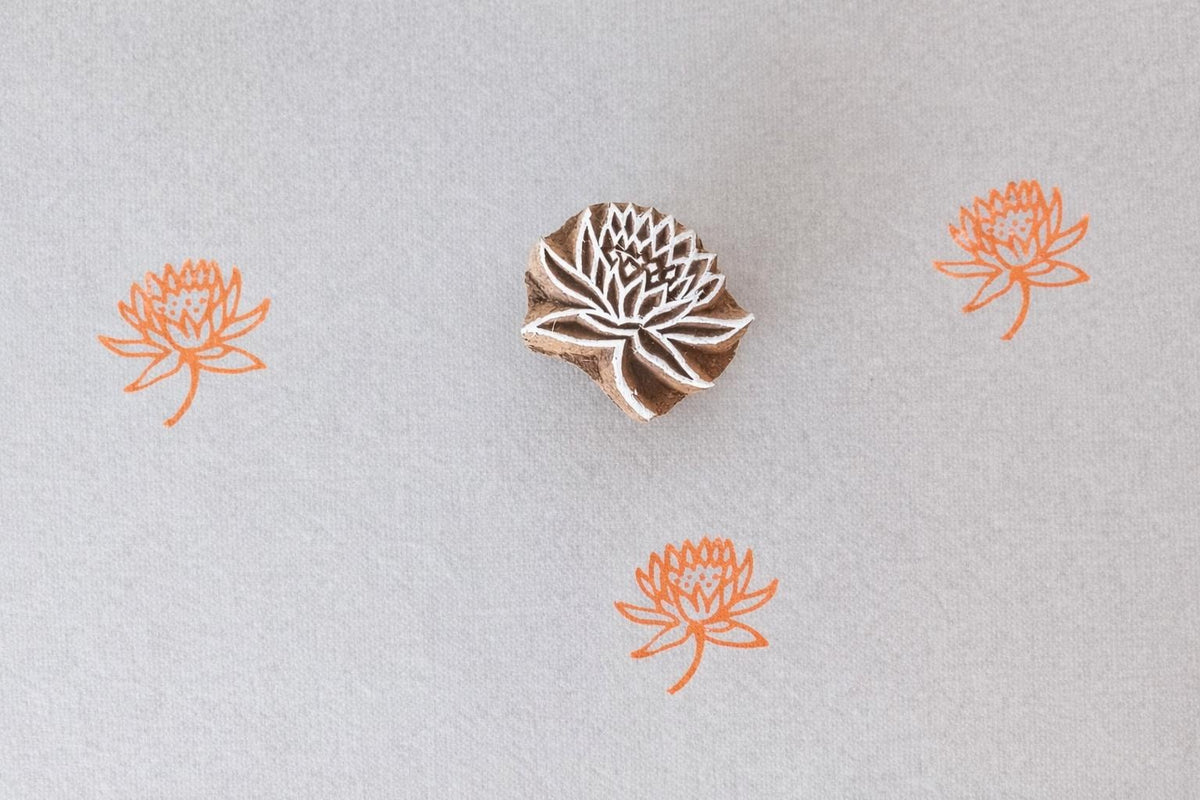 Hand carved lotus mini stamp printing orange floral pattern on fabric