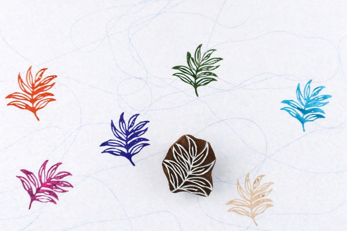 Hand carved Indian wooden block featuring layered tropical foliage pattern printed in multiple colors on white background for textile printing, pottery, clay, and paper crafts.