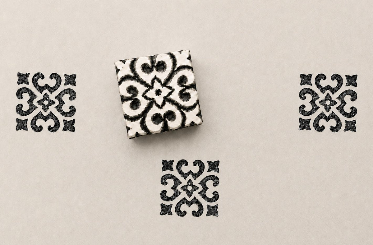 Hand carved wooden ornamental tile block stamp printing symmetrical baroque style geometric motif in black ink on cream paper