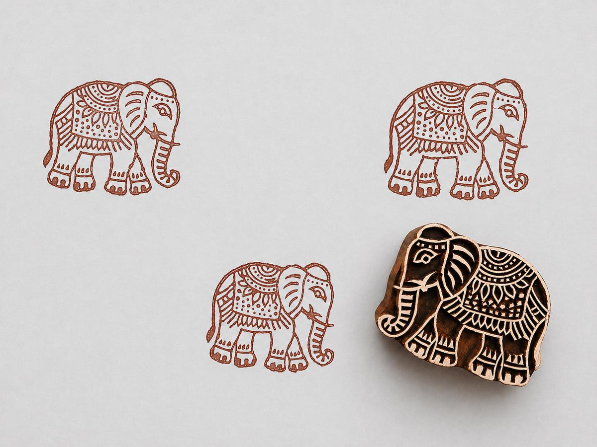 Hand carved wooden elephant block stamp printing decorative elephant pattern on white paper