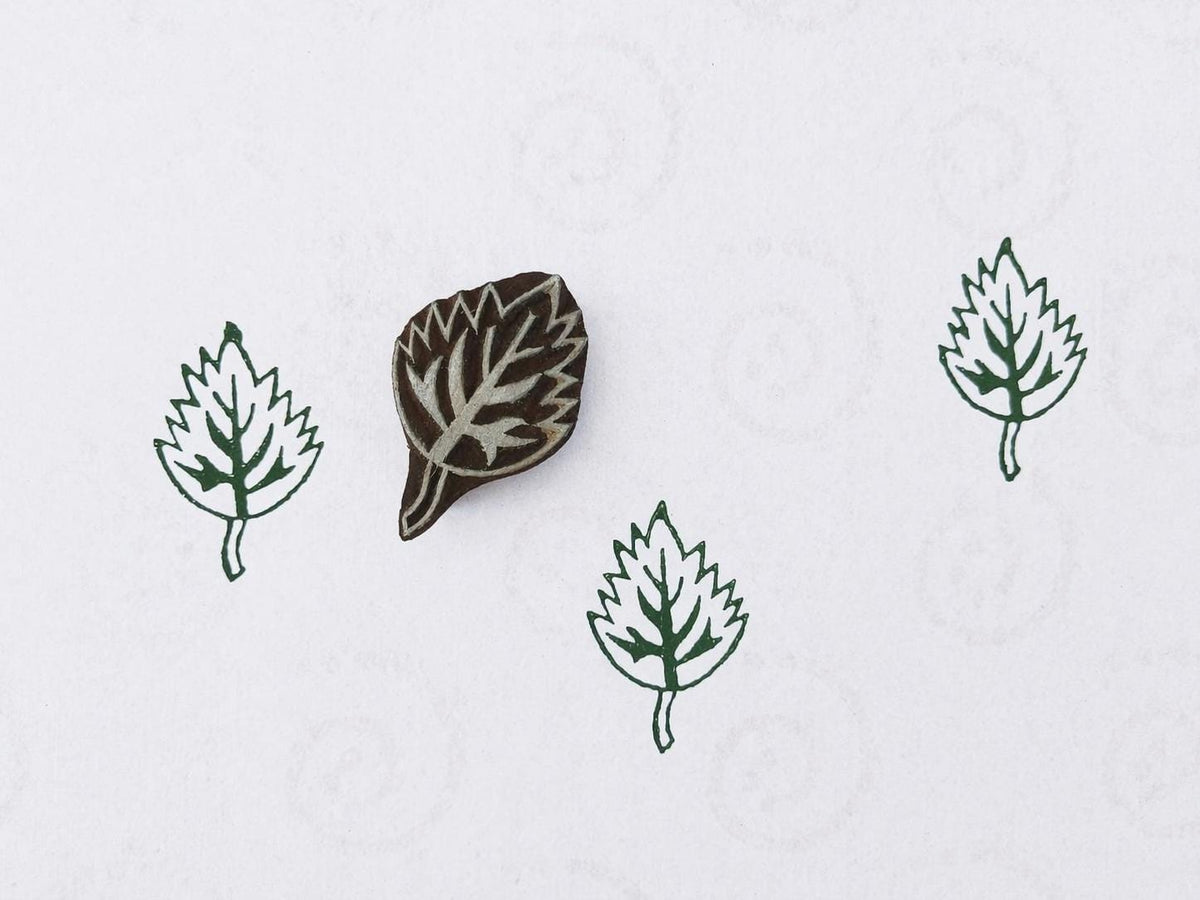 Hand carved wooden printing block with a serrated woodland leaf motif for textile printing, botanical crafts, and nature-inspired surface patterns.