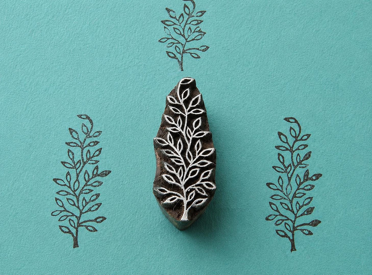Hand carved Indian wooden block featuring delicate wild branch botanical pattern printed in black on turquoise background for textile printing, pottery, clay, and paper crafts.