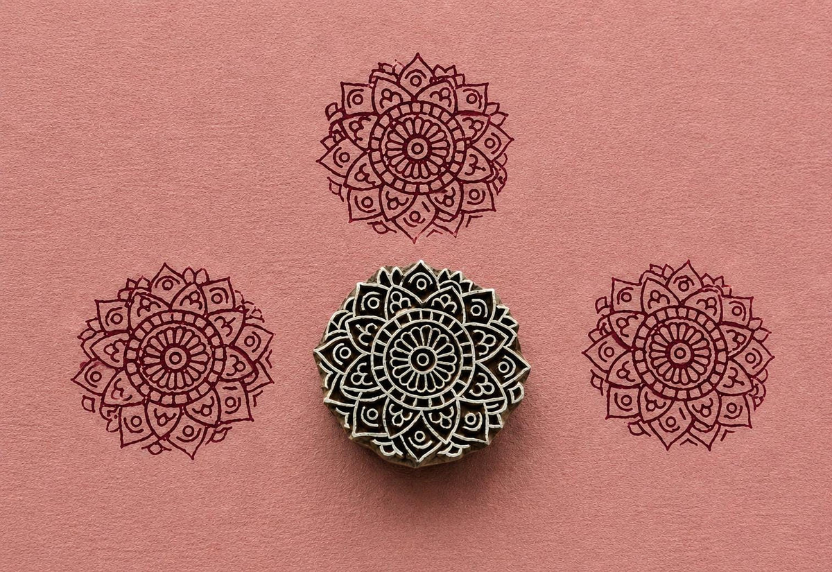 Hand carved Sacred Heart Mandala wooden block stamp with burgundy impressions on blush pink handmade paper.