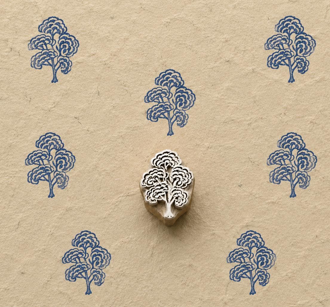 Hand carved Cloud Blossom Tree wooden block stamp with blue impressions on natural handmade paper.