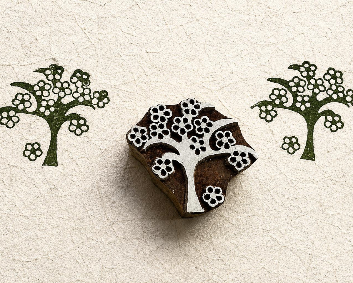 Hand carved folk blossom tree wood block stamp with repeating floral tree impressions on handmade paper