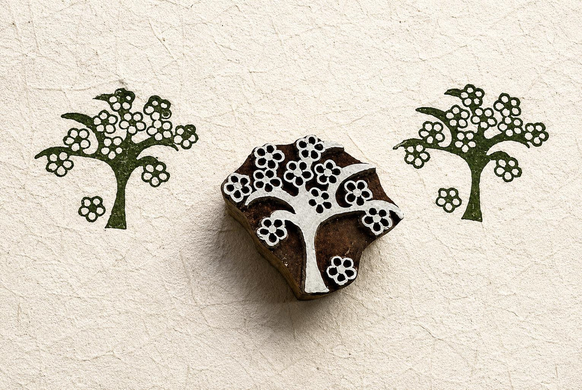 Hand carved folk blossom tree wood block stamp with repeating floral tree impressions on handmade paper