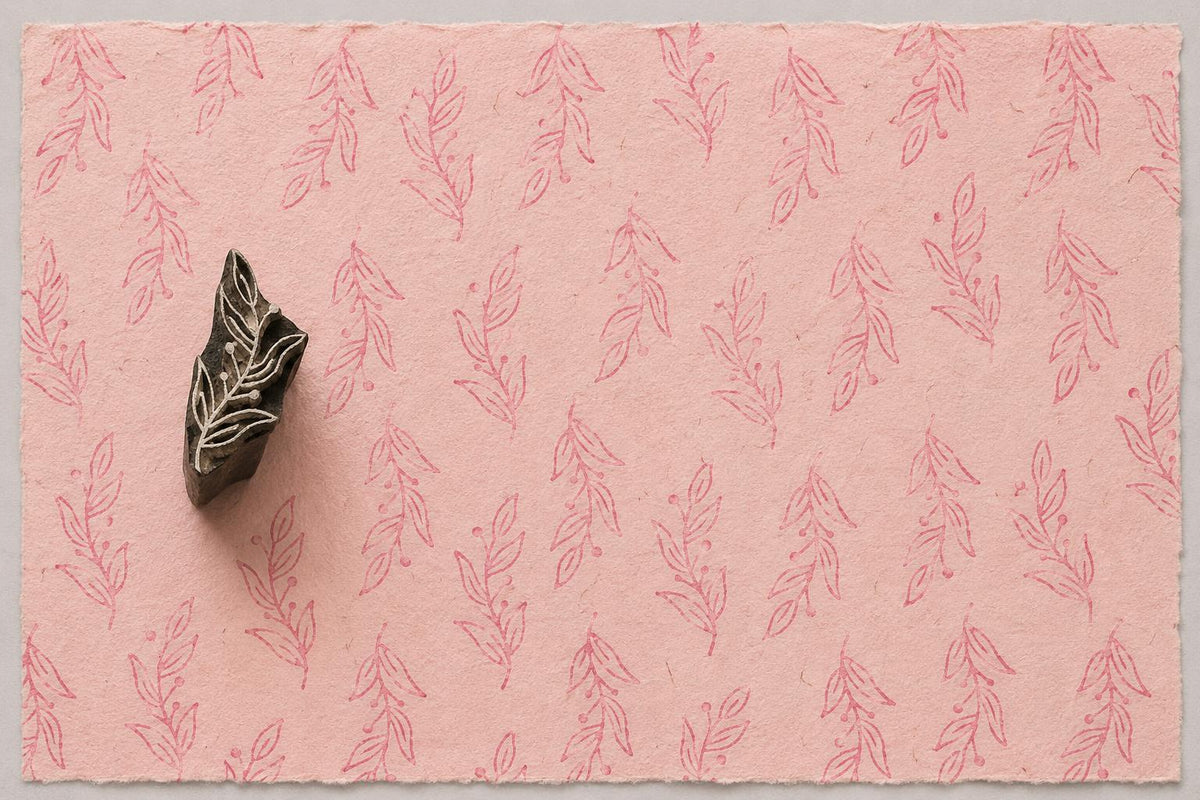 Hand carved Berry Branch wooden printing block with soft pink botanical impressions on handmade blush paper.