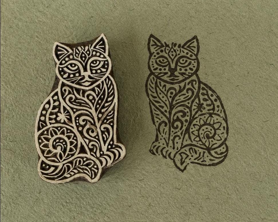 Hand carved Ornate Cat wooden printing block with detailed black cat impression on sage green handmade paper.