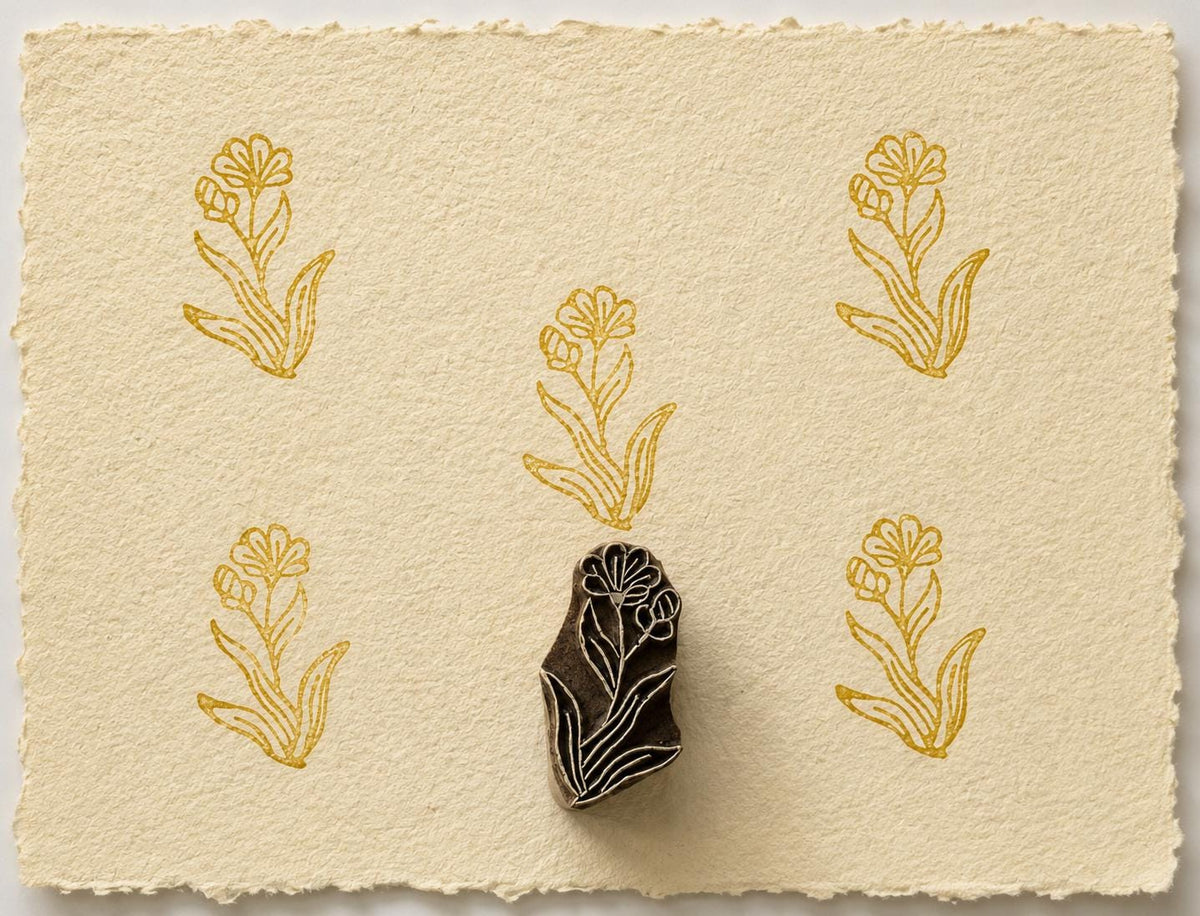 Jungle Flower wooden printing block with repeated ochre floral impressions on handmade paper