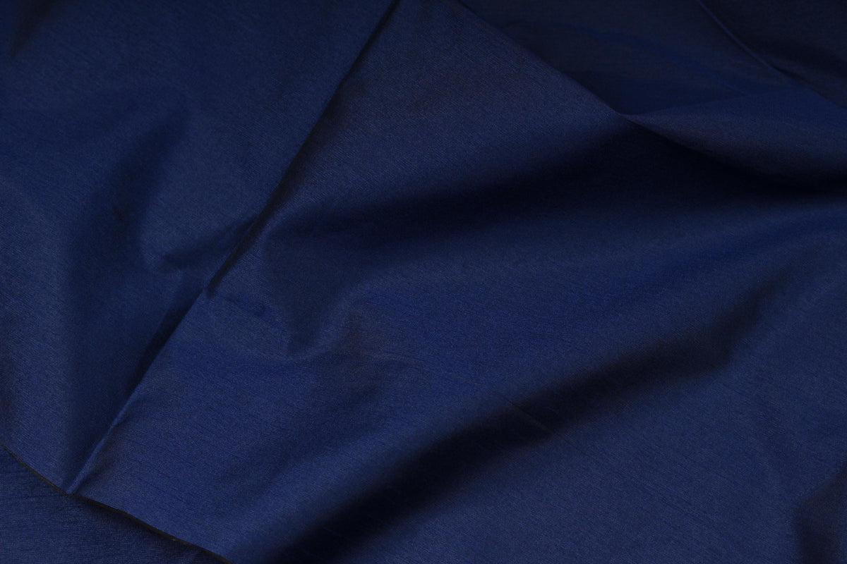 Royal blue faux dupioni fabric draped in soft folds to show its texture and sheen
