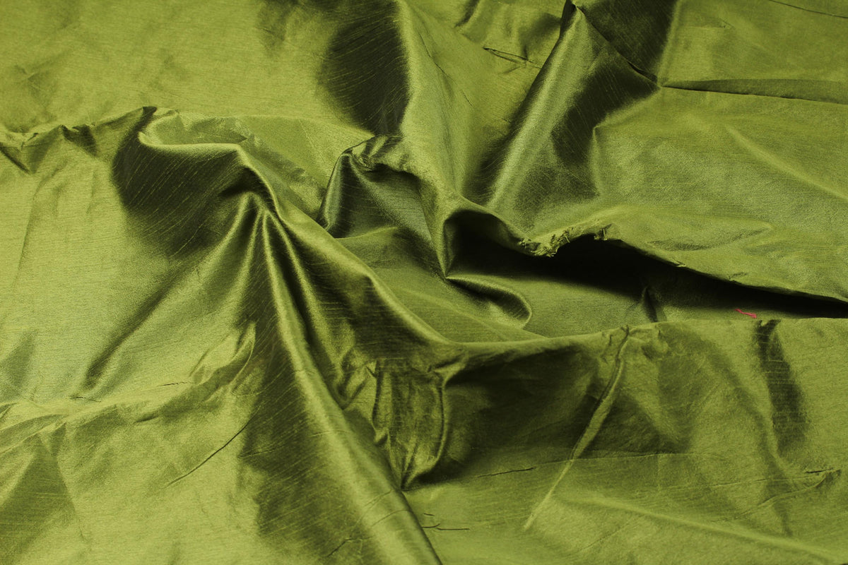 Olive green faux dupioni silk fabric arranged in folds to show its subtle sheen and textured surface.