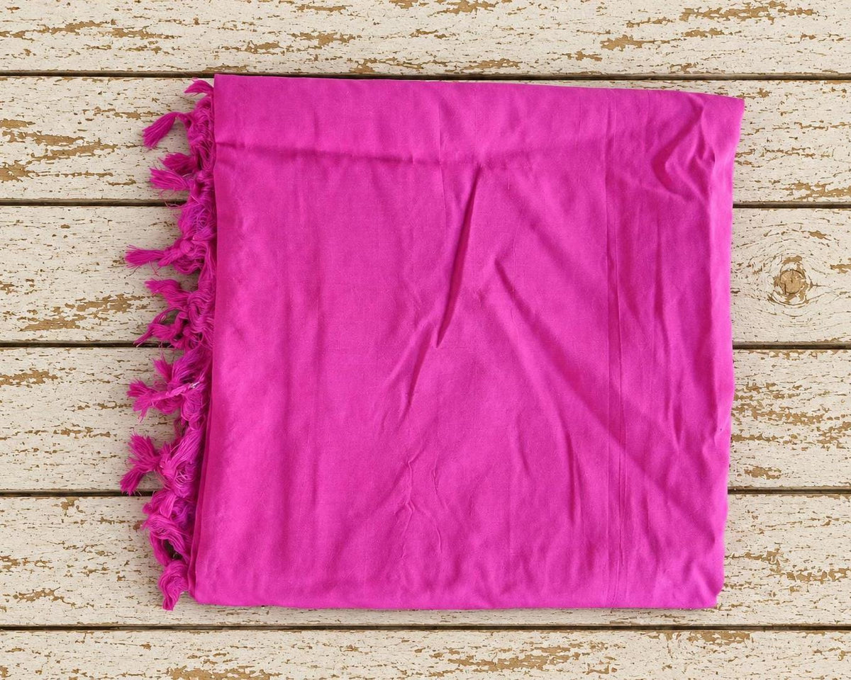 Fuchsia pink silk sari textile folded to show the vivid colour and generous amount of fabric