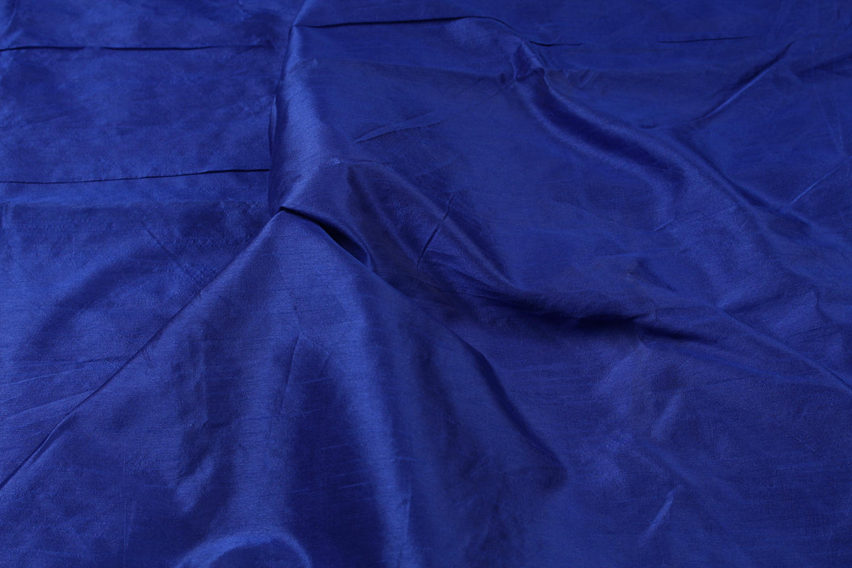 Deep blue Midnight Sapphire faux dupioni fabric arranged in soft folds, showing its rich colour and gentle sheen.