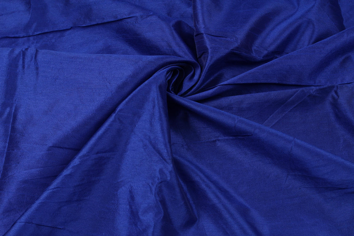 Midnight Sapphire faux dupioni fabric draped in flowing folds, showing the deep sapphire blue colour and textured faux silk surface.