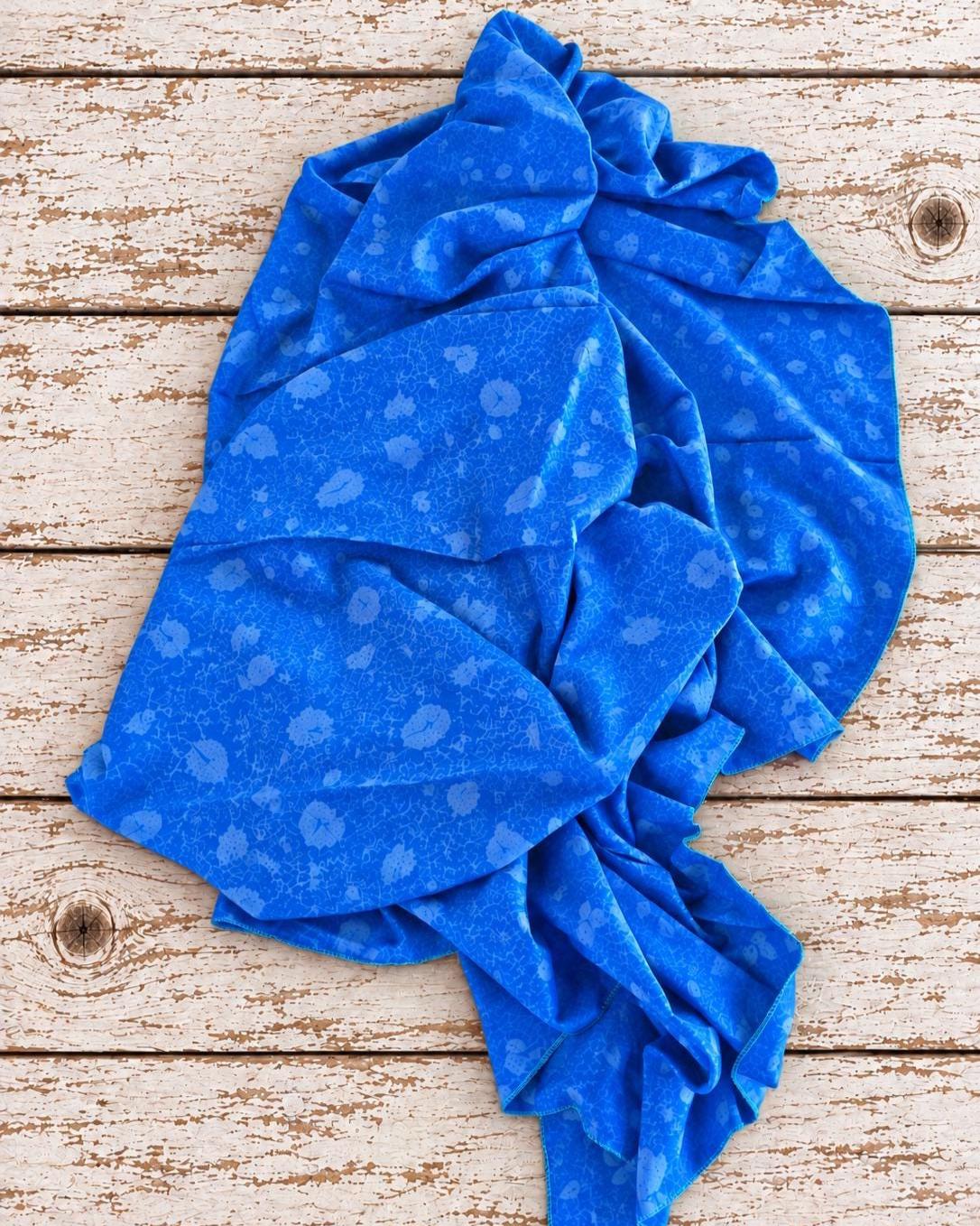Vintage cobalt blue Indian sari silk fabric draped to show its soft texture and intricate tonal floral paisley print