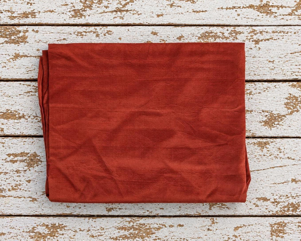 burnt orange vintage sari silk fabric piece folded to show approximate one metre size