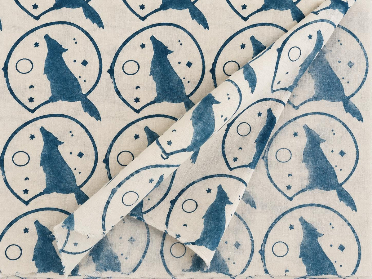 Indigo wolf and moon motifs on soft cream hand block printed cotton fabric