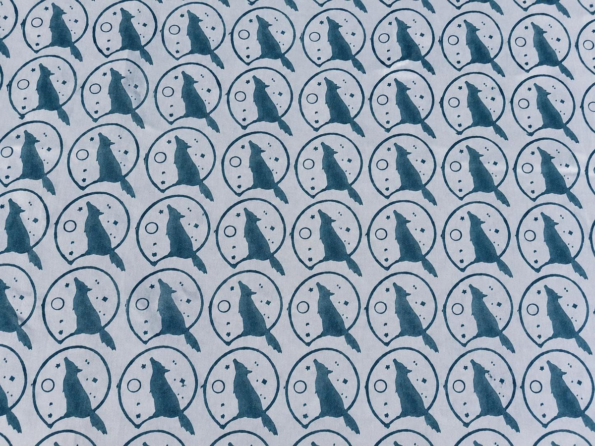 Moonlit Wolf hand block printed cotton fabric with muted blue wolf and moon motifs