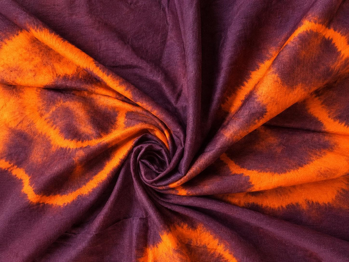 Close-up of burnt orange and plum tie-dye patterns on vintage sari silk fabric