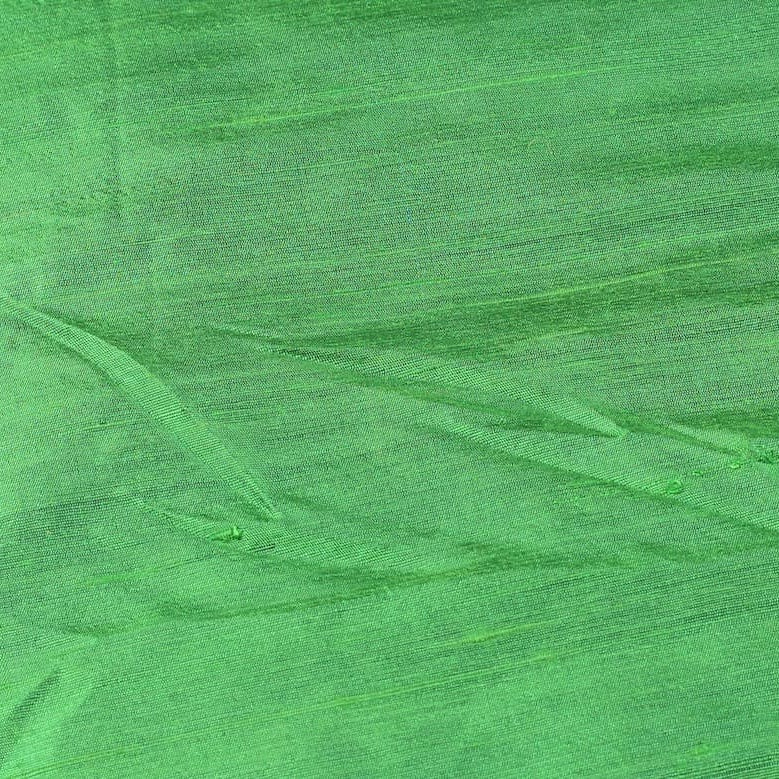 Close-up of Spring Green Dupion Silk Fabric showing natural slub texture, woven silk detail, and fresh vibrant green colour
