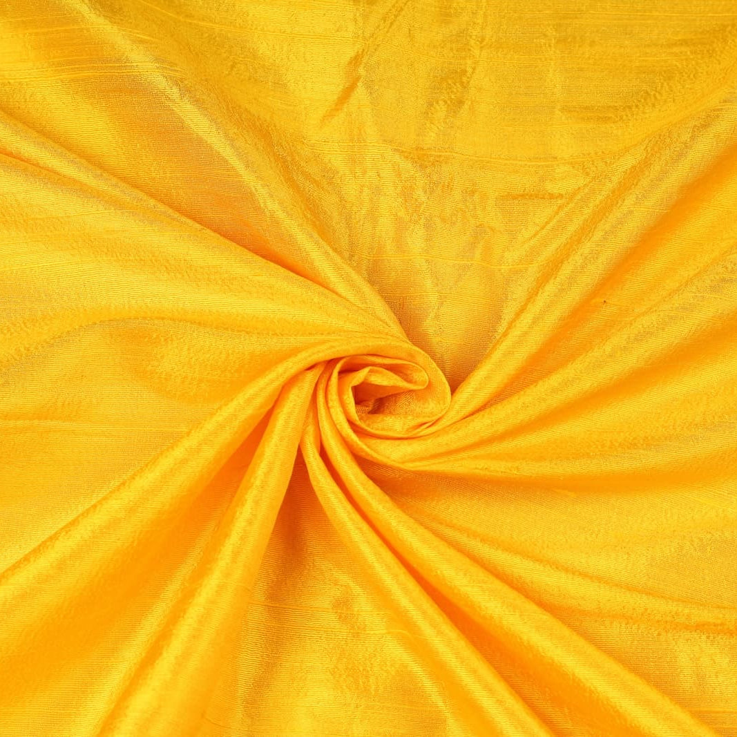 Golden Yellow Dupion Silk Fabric arranged in elegant swirling folds highlighting its luminous sheen, crisp texture, and vibrant golden colouring