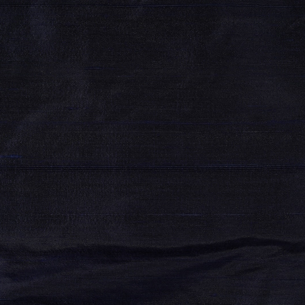 Close-up of Deep Navy Dupion Silk Fabric showing natural slub texture, woven silk detail, and subtle tonal variation